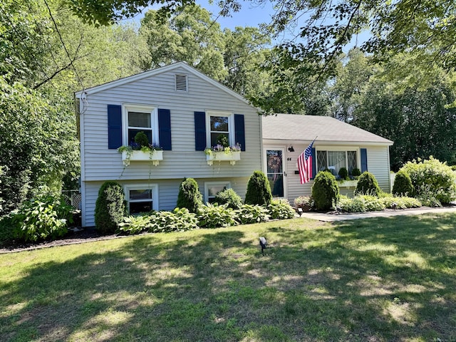 44 Coolidge St, Windsor Locks, CT 06096 - tri-level home featuring a front lawn and view of scattered trees