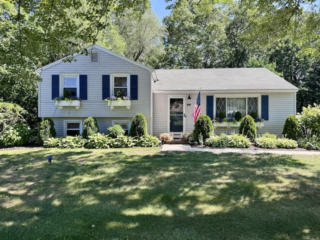 44 Coolidge St, Windsor Locks, CT 06096 - tri-level home featuring a front yard and view of wooded area