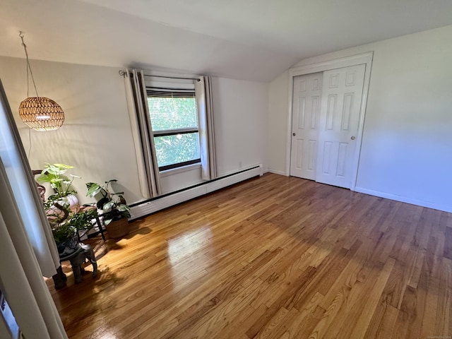 44 Coolidge St, Windsor Locks, CT 06096 - unfurnished bedroom featuring wood finished floors, lofted ceiling, a chandelier, and a baseboard radiator