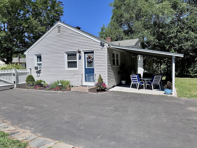 44 Coolidge St, Windsor Locks, CT 06096 - rear view of house with a chimney and a patio