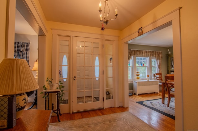23 E St, Stafford, CT 06076 - entryway with wood finished floors and a chandelier
