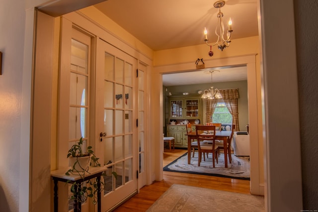 23 E St, Stafford, CT 06076 - doorway to outside featuring a chandelier and wood finished floors