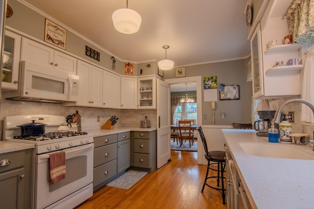 23 E St, Stafford, CT 06076 - kitchen featuring white appliances, gray cabinets, light wood finished floors, crown molding, and light countertops