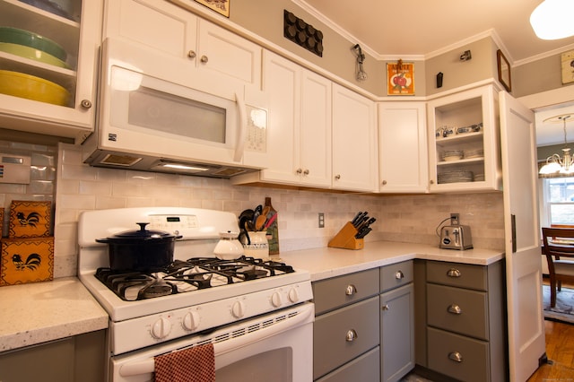 23 E St, Stafford, CT 06076 - kitchen with white appliances, gray cabinets, backsplash, glass insert cabinets, and crown molding