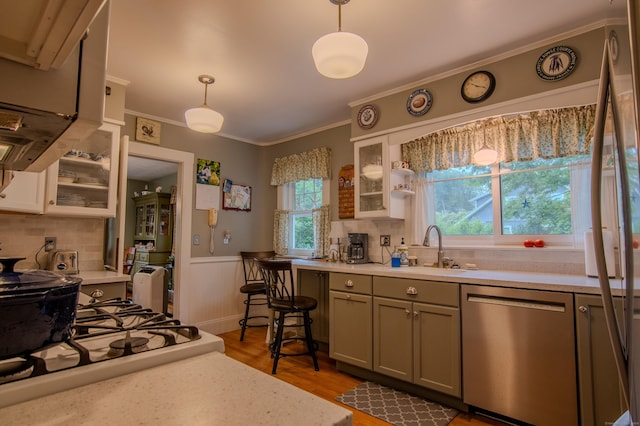 23 E St, Stafford, CT 06076 - kitchen with dishwasher, healthy amount of natural light, light countertops, ornamental molding, and a wainscoted wall