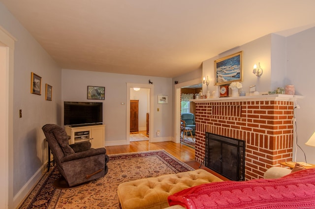 23 E St, Stafford, CT 06076 - living area featuring wood finished floors and a brick fireplace