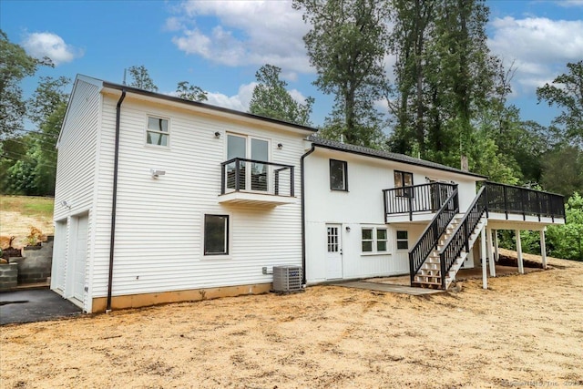 12 Deer Run Rd, Brookfield, CT 06804 - rear view of house with stairway, a wooden deck, and an attached garage