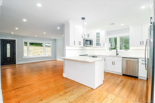 12 Deer Run Rd, Brookfield, CT 06804 - kitchen with appliances with stainless steel finishes, open floor plan, backsplash, white cabinetry, and recessed lighting