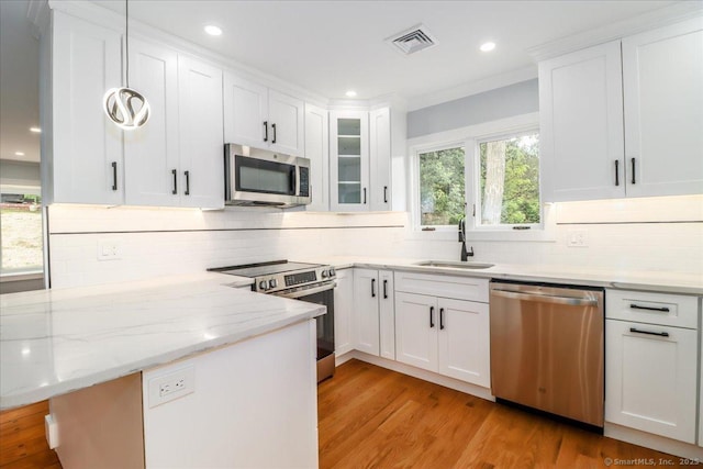 12 Deer Run Rd, Brookfield, CT 06804 - kitchen featuring stainless steel appliances, backsplash, white cabinetry, recessed lighting, and ornamental molding