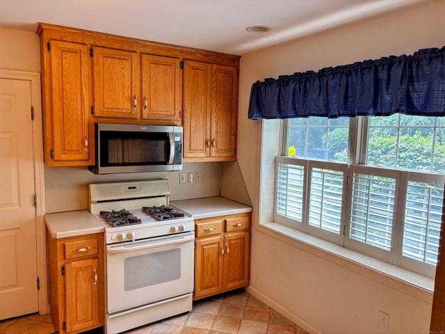 2 Apple Blossom Ln, East Lyme, CT 06357 - kitchen with stainless steel microwave, white range with gas cooktop, healthy amount of natural light, and light countertops