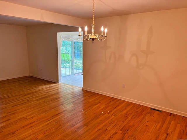2 Apple Blossom Ln, East Lyme, CT 06357 - spare room featuring a chandelier and wood finished floors