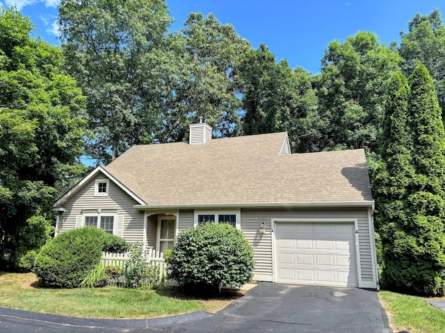2 Apple Blossom Ln, East Lyme, CT 06357 - view of front facade with a garage, driveway, a chimney, and roof with shingles