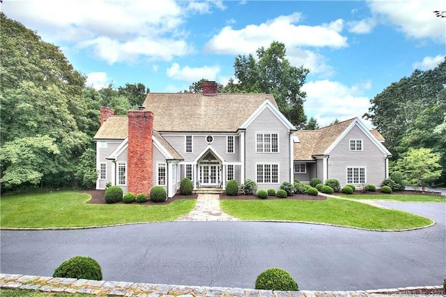 30 Soundview Farm Rd, Weston, CT 06883 - view of front of home with a chimney and a front lawn