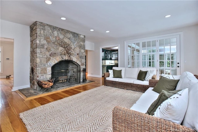 30 Soundview Farm Rd, Weston, CT 06883 - living area with wood-type flooring, a stone fireplace, and recessed lighting