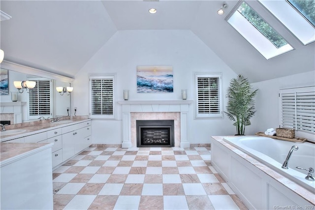 30 Soundview Farm Rd, Weston, CT 06883 - full bath featuring a high end fireplace, a bath, vaulted ceiling, vanity, and a skylight