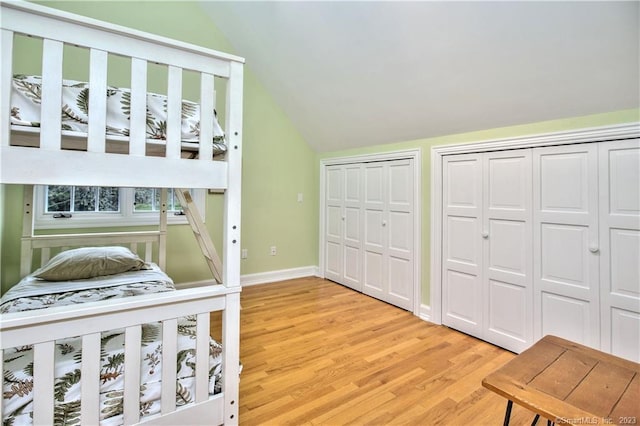 30 Soundview Farm Rd, Weston, CT 06883 - bedroom featuring lofted ceiling, light wood-style floors, and two closets