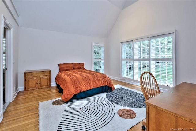 30 Soundview Farm Rd, Weston, CT 06883 - bedroom with multiple windows, lofted ceiling, and light wood-type flooring