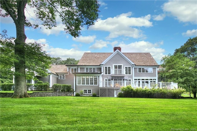 30 Soundview Farm Rd, Weston, CT 06883 - rear view of house featuring a yard, a chimney, and a deck