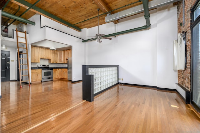 149 Water St Apt 15, Norwalk, CT 06854 - unfurnished living room featuring a high ceiling, light wood-type flooring, ceiling fan, and a wooden ceiling with exposed beams