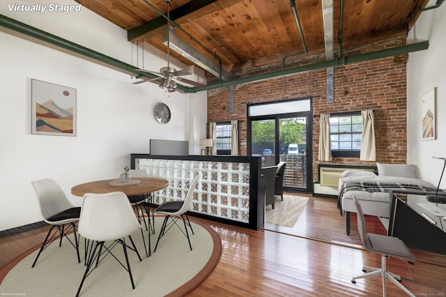 149 Water St Apt 15, Norwalk, CT 06854 - dining space with a wooden ceiling with exposed beams, wood finished floors, brick wall, and a ceiling fan