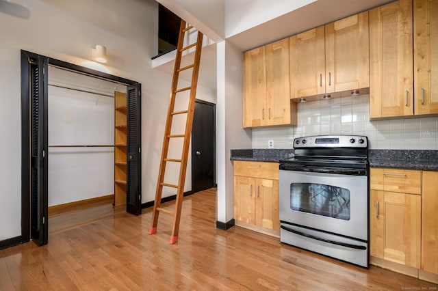 149 Water St Apt 15, Norwalk, CT 06854 - kitchen featuring stainless steel electric range, light wood-type flooring, tasteful backsplash, and light brown cabinets