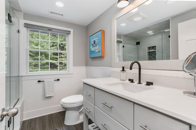 101 Golden Hill St, Trumbull, CT 06611 - bathroom featuring wood finished floors, vanity, a shower with door, and wainscoting