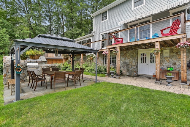 101 Golden Hill St, Trumbull, CT 06611 - rear view of house with a gazebo, a lawn, a patio area, stone siding, and outdoor dining space