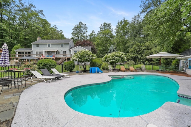 101 Golden Hill St, Trumbull, CT 06611 - view of swimming pool featuring a patio area, a pool with connected hot tub, and view of wooded area