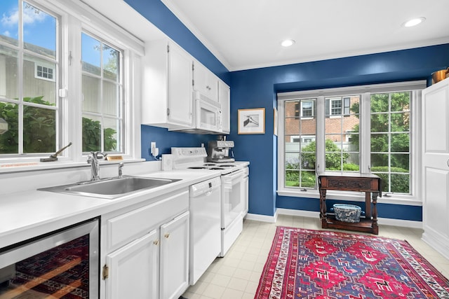 312 Elm St Apt 9, New Canaan, CT 06840 - kitchen featuring wine cooler, white appliances, white cabinetry, light countertops, and light tile patterned flooring
