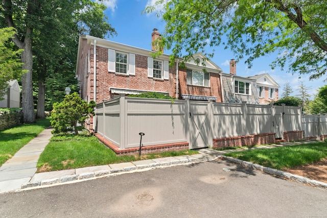 312 Elm St Apt 9, New Canaan, CT 06840 - view of front of house with brick siding and a chimney