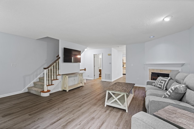 34 Village View Ter Unit 34, Meriden, CT 06451 - living area with wood finished floors, stairway, a tiled fireplace, and recessed lighting