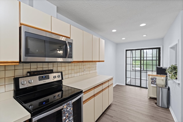 34 Village View Ter Unit 34, Meriden, CT 06451 - kitchen with stainless steel appliances, light wood-style flooring, light countertops, backsplash, and recessed lighting