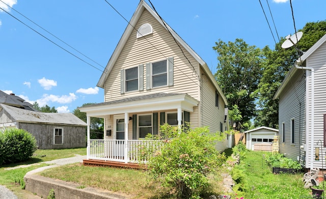 169 Mount Pleasant St, Norwich, CT 06360 - view of front of house featuring covered porch, an outdoor structure, a detached garage, and a front yard