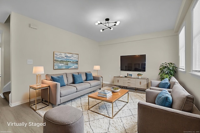 169 Mount Pleasant St, Norwich, CT 06360 - living room featuring wood finished floors and a chandelier