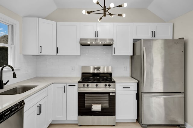 169 Mount Pleasant St, Norwich, CT 06360 - kitchen featuring stainless steel appliances, under cabinet range hood, vaulted ceiling, light stone countertops, and white cabinetry