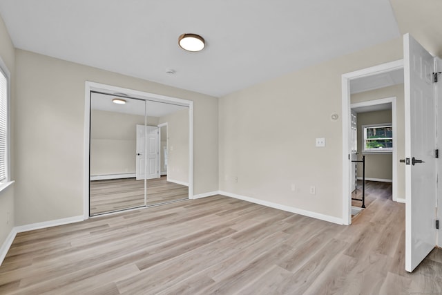 169 Mount Pleasant St, Norwich, CT 06360 - empty room with a baseboard heating unit and light wood-style flooring