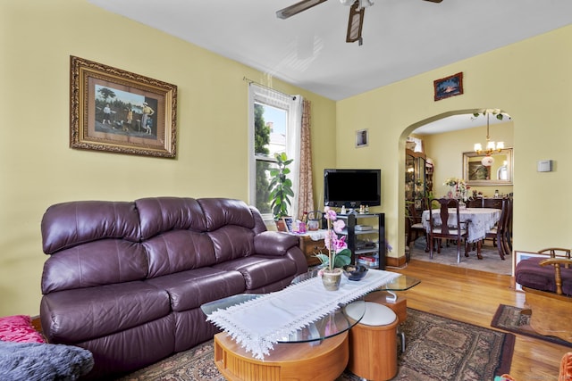 33 Aetna St, Naugatuck, CT 06770 - living room with arched walkways, ceiling fan, wood finished floors, and a chandelier