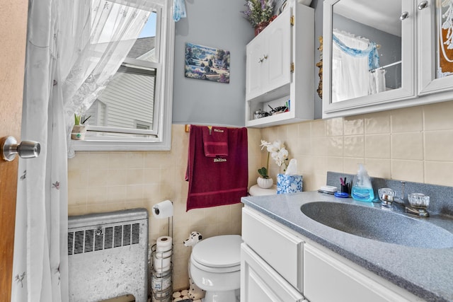 33 Aetna St, Naugatuck, CT 06770 - bathroom with radiator heating unit, tile walls, vanity, a shower with curtain, and backsplash