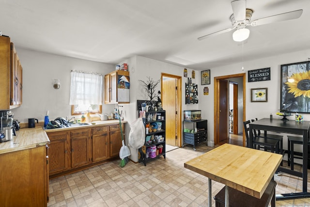 33 Aetna St, Naugatuck, CT 06770 - kitchen with ceiling fan, light countertops, brown cabinets, and brick patterned floors