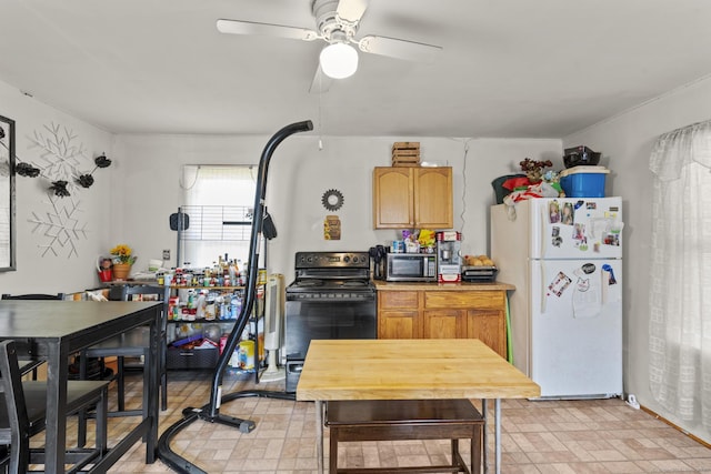 33 Aetna St, Naugatuck, CT 06770 - kitchen with freestanding refrigerator, black / electric stove, stainless steel microwave, and ceiling fan