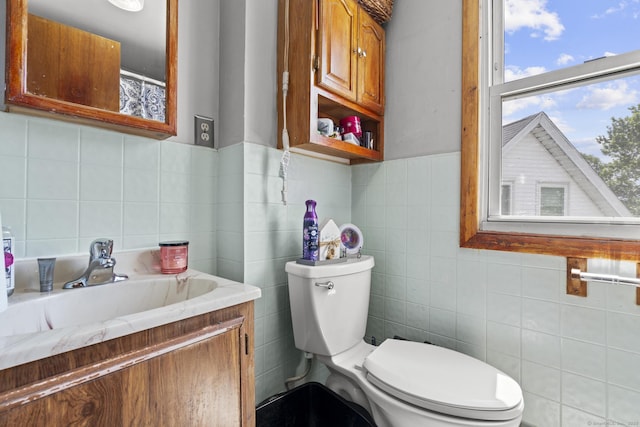 33 Aetna St, Naugatuck, CT 06770 - bathroom with tile walls, vanity, and tasteful backsplash