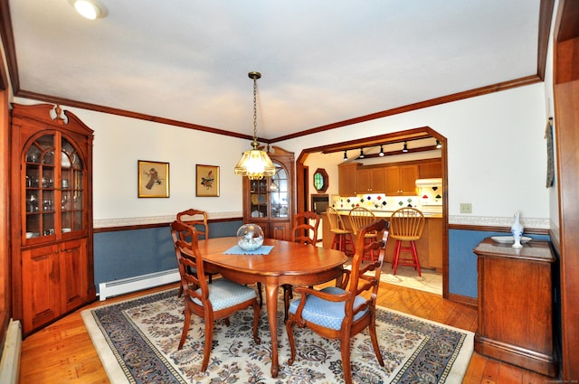 172 Bentley Cir, Goshen, CT 06756 - dining room with a baseboard radiator, light wood-style flooring, a wainscoted wall, and ornamental molding