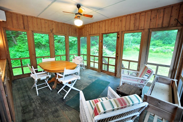 172 Bentley Cir, Goshen, CT 06756 - sunroom with ceiling fan, a deck, outdoor dining area, and wood walls