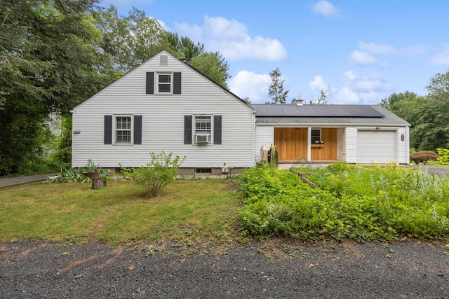 931 Chestnut Hill Rd, Glastonbury, CT 06073 - view of front of house with roof mounted solar panels, an attached garage, a front yard, and cooling unit