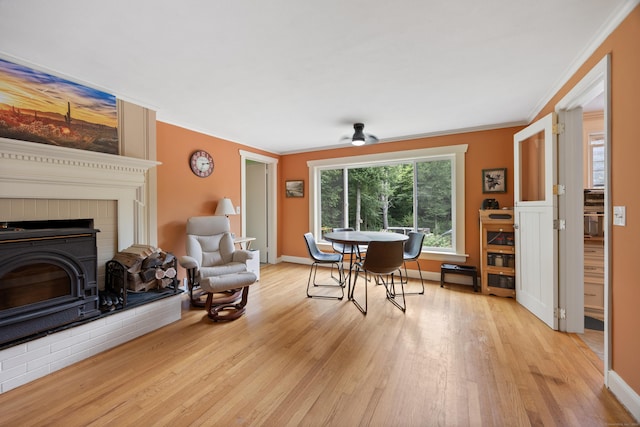 931 Chestnut Hill Rd, Glastonbury, CT 06073 - dining room with ornamental molding, light wood finished floors, a fireplace, and a ceiling fan