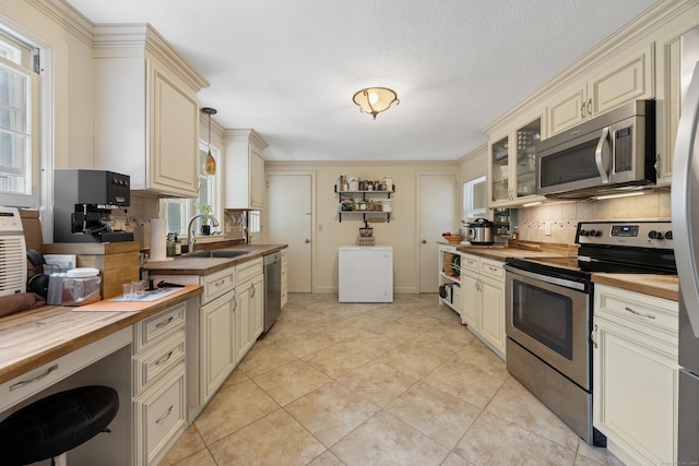 931 Chestnut Hill Rd, Glastonbury, CT 06073 - kitchen featuring butcher block counters, stainless steel appliances, and cream cabinets