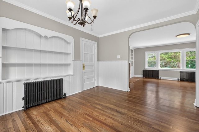 3 Moody Ln, Danbury, CT 06811 - unfurnished living room featuring radiator heating unit, arched walkways, a chandelier, a wainscoted wall, and ornamental molding
