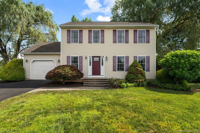 62 Peach Tree Ln, Berlin, CT 06037 - colonial house with an attached garage, asphalt driveway, and a front lawn