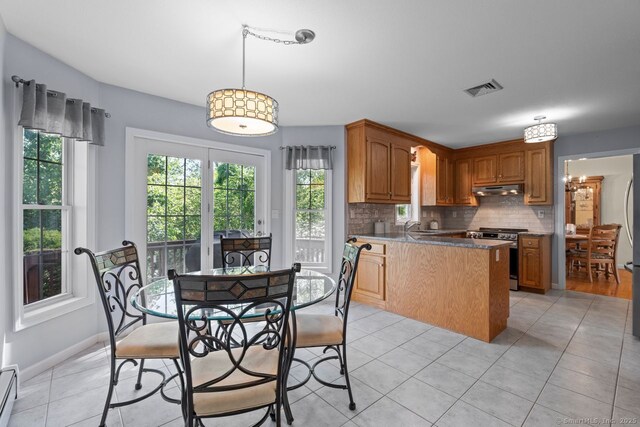 62 Peach Tree Ln, Berlin, CT 06037 - kitchen featuring appliances with stainless steel finishes, under cabinet range hood, a peninsula, and light tile patterned floors