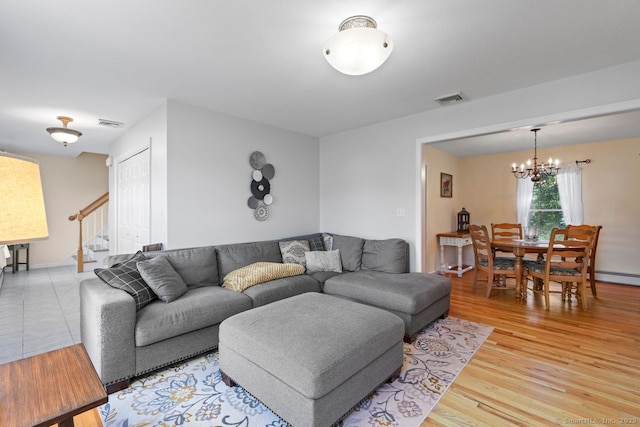62 Peach Tree Ln, Berlin, CT 06037 - living area featuring a chandelier, stairs, and light wood-style floors